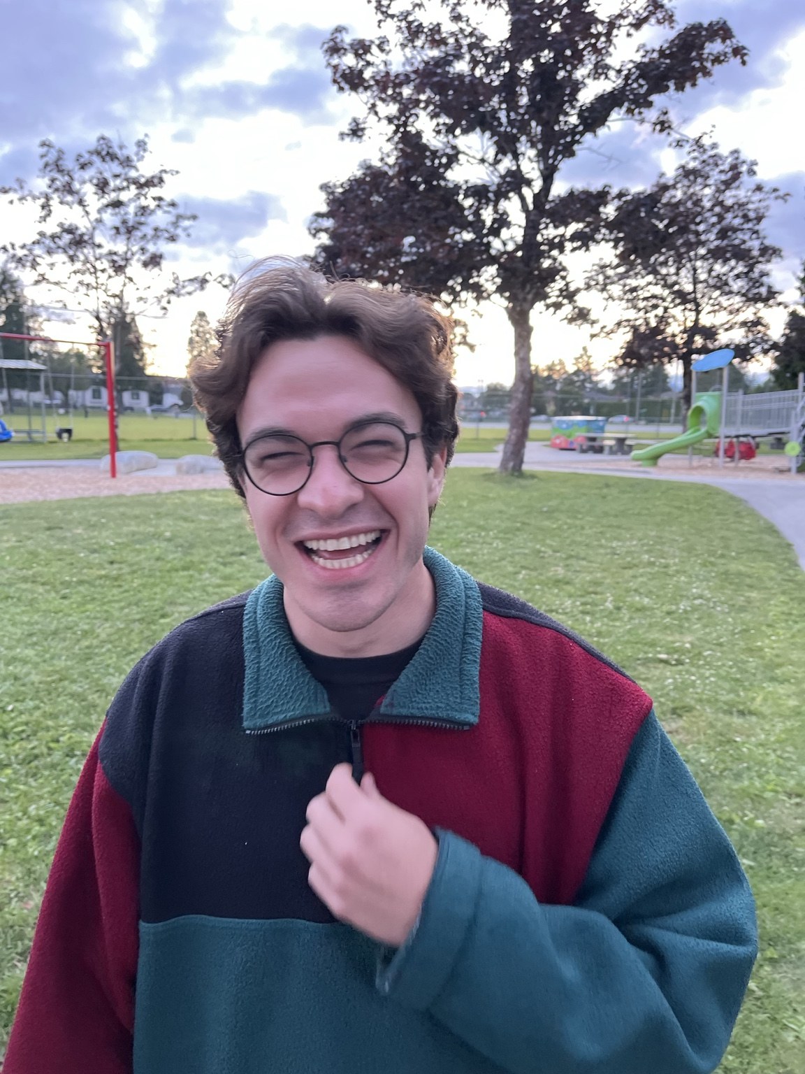Jared laughing in a park