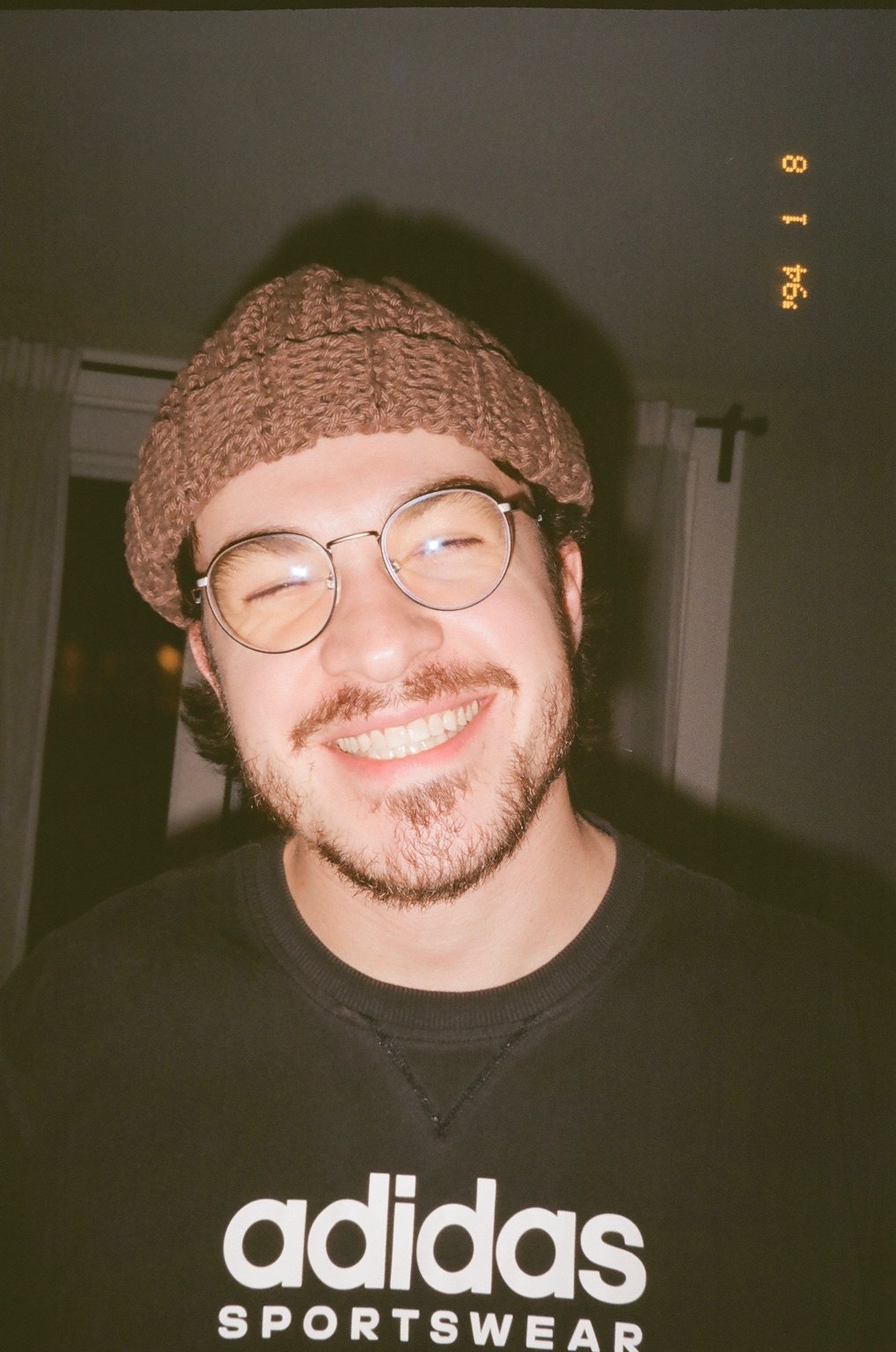 Jared smiling in glasses and a knitted hat